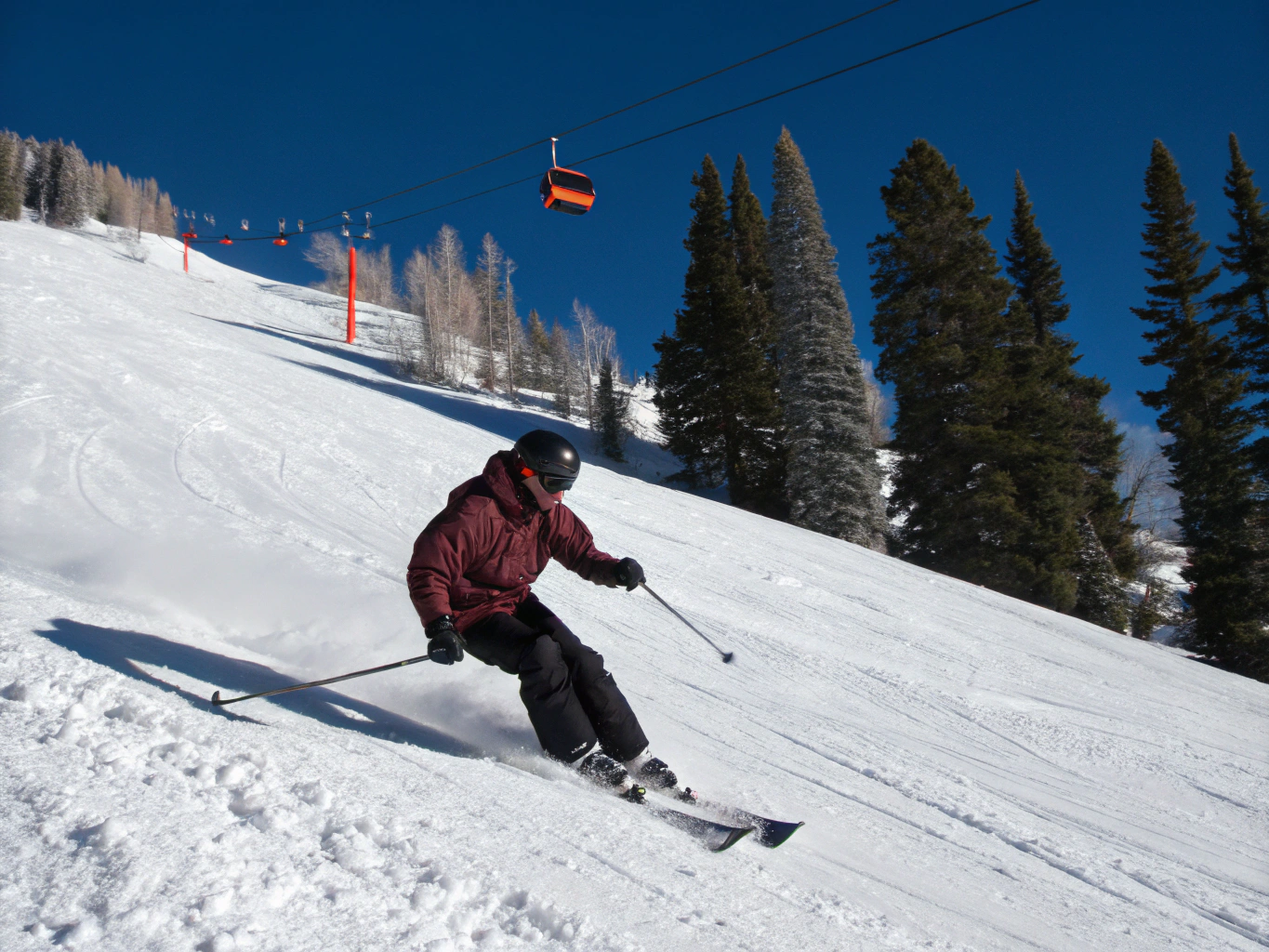 Athlete carving through steep Montana powder snow demonstrating high-demand knee stability and mechanics